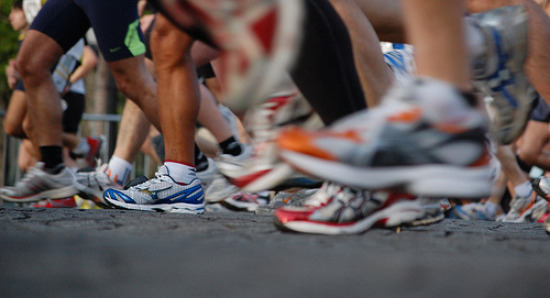 Runners racing with a closeup on their shoes